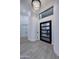 Bright foyer featuring a modern chandelier, high ceilings, and a sleek black door with glass panels at 11578 N 80Th Pl, Scottsdale, AZ 85260