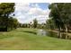 Scenic golf course view with a water hazard and fountain surrounded by lush greenery at 11578 N 80Th Pl, Scottsdale, AZ 85260