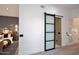Hallway with a frosted glass barn door leading to another room and a view of the bedoom at 11578 N 80Th Pl, Scottsdale, AZ 85260