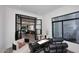 Alternate view of home office with views of the backyard, stylish seating, and a modern black desk at 11578 N 80Th Pl, Scottsdale, AZ 85260