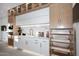 Sleek kitchen featuring marble backsplash, modern appliances, custom cabinets with pull-out shelving, and stylish finishes at 11578 N 80Th Pl, Scottsdale, AZ 85260
