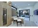 Cozy kitchen boasts a modern island, barstool seating, and a view of the backyard through large sliding doors at 11578 N 80Th Pl, Scottsdale, AZ 85260