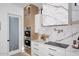 Kitchen featuring modern appliances, marble countertops, custom cabinetry, and a stainless steel range hood at 11578 N 80Th Pl, Scottsdale, AZ 85260