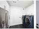 Clean laundry room with modern washer and dryer, stainless steel refrigerator and ample storage at 11578 N 80Th Pl, Scottsdale, AZ 85260