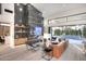 Modern living room showcasing a stylish fireplace, built-in shelving, comfortable seating, and access to the backyard pool at 11578 N 80Th Pl, Scottsdale, AZ 85260