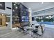 Modern living room boasts a sleek fireplace, high ceilings, and an open layout leading to the outdoor pool area at 11578 N 80Th Pl, Scottsdale, AZ 85260