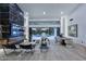 Expansive living room with a marble fireplace, floor-to-ceiling windows, and seamless access to the pool area at 11578 N 80Th Pl, Scottsdale, AZ 85260