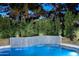 Close up of a pristine pool with a stunning waterfall feature and meticulously maintained landscaping at 11578 N 80Th Pl, Scottsdale, AZ 85260