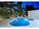 Inviting pool with a unique waterfall feature and lush landscaping, perfect for relaxing evenings at 11578 N 80Th Pl, Scottsdale, AZ 85260