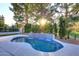 Serene backyard pool with a waterfall feature, surrounded by lush greenery and decorative landscaping at 11578 N 80Th Pl, Scottsdale, AZ 85260