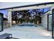 A luxurious outdoor space features a modern pool with integrated waterfall and an outdoor kitchen, creating an ideal entertainment space at 11578 N 80Th Pl, Scottsdale, AZ 85260