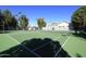 Well maintained tennis courts with green surface, netting, and perimeter fence at 11578 N 80Th Pl, Scottsdale, AZ 85260