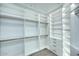 Bright, spacious walk-in closet features custom shelving, drawers, and ample storage space at 11578 N 80Th Pl, Scottsdale, AZ 85260