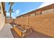 Enclosed backyard with a planter, gravel ground cover, and privacy fence at 11844 N 146Th Ave, Surprise, AZ 85379