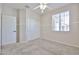 Bright bedroom with plush carpeting, double closet doors, and a large window at 11844 N 146Th Ave, Surprise, AZ 85379