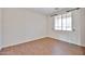 Bright bedroom with wood flooring and large window at 11844 N 146Th Ave, Surprise, AZ 85379