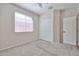 This bedroom features neutral walls, carpet flooring, and a window offering natural light at 11844 N 146Th Ave, Surprise, AZ 85379