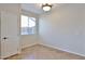 A bright room with tile floors, a window, and a large closet at 11844 N 146Th Ave, Surprise, AZ 85379