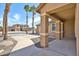 Inviting covered front porch with decorative columns, concrete driveway and desert landscaping at 11844 N 146Th Ave, Surprise, AZ 85379