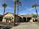 Charming single-story home with desert landscaping and tall palm trees in the front yard at 11844 N 146Th Ave, Surprise, AZ 85379