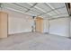 Well-lit garage with ample storage cabinets and epoxy flooring at 11844 N 146Th Ave, Surprise, AZ 85379