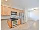 This kitchen is equipped with stainless steel appliances, light wood cabinets, and tiled floors at 11844 N 146Th Ave, Surprise, AZ 85379