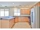 Bright kitchen featuring stainless steel appliances, light wood cabinets, tiled floors and granite countertops at 11844 N 146Th Ave, Surprise, AZ 85379