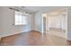 Bright, open living area features wood flooring and a large window at 11844 N 146Th Ave, Surprise, AZ 85379