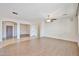 Bright, open-concept living room with tile and wood flooring and ceiling fan at 11844 N 146Th Ave, Surprise, AZ 85379