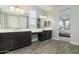 Bathroom featuring double sinks, well-lit vanity area, and wood-look flooring, creating a spa-like atmosphere at 12031 E Chevelon Trl, Gold Canyon, AZ 85118