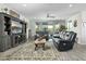 Comfortable living room with stylish furniture, a large TV, and sliding glass doors to the outdoor patio at 12031 E Chevelon Trl, Gold Canyon, AZ 85118