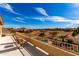 A balcony view showcasing an outdoor patio set, desert landscape and a community pool at 1213 W Deoni Trl, San Tan Valley, AZ 85143