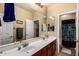Bathroom featuring double sinks, large mirror, and a separate toilet and shower area at 1213 W Deoni Trl, San Tan Valley, AZ 85143