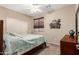 Cozy bedroom with carpet, natural light, a queen bed with patterned quilt, and a closet at 1213 W Deoni Trl, San Tan Valley, AZ 85143