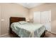 Bedroom featuring a queen bed with a patterned quilt, neutral walls, carpet and a closet at 1213 W Deoni Trl, San Tan Valley, AZ 85143