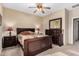 Cozy bedroom featuring wood furnishings, neutral walls, and plush carpeting at 1213 W Deoni Trl, San Tan Valley, AZ 85143