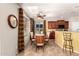 An inviting dining room features a tile floor, decorative ceiling fan, and window with a view at 1213 W Deoni Trl, San Tan Valley, AZ 85143