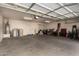 Spacious garage with ample storage space and a well-lit interior, perfect for parking and projects at 1213 W Deoni Trl, San Tan Valley, AZ 85143