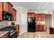 This modern kitchen features stainless steel appliances and granite countertops at 1213 W Deoni Trl, San Tan Valley, AZ 85143