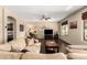 This spacious living room is decorated with a large comfortable couch, wood floors, and warm lighting at 1213 W Deoni Trl, San Tan Valley, AZ 85143