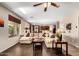 Cozy and expansive living room featuring a large comfortable couch and access to dining area and kitchen at 1213 W Deoni Trl, San Tan Valley, AZ 85143