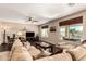 Spacious living room with wood floors and views of the outdoor pool through multiple windows at 1213 W Deoni Trl, San Tan Valley, AZ 85143