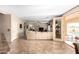 Large living room with access to a beautiful outdoor swimming pool, perfect for relaxation and entertaining at 1213 W Deoni Trl, San Tan Valley, AZ 85143