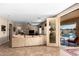 A well-lit living room features an open glass door to a view of the outdoor swimming pool at 1213 W Deoni Trl, San Tan Valley, AZ 85143