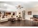 Spacious living room with a large sectional sofa, wood floors, and an open floor plan to the kitchen at 1213 W Deoni Trl, San Tan Valley, AZ 85143