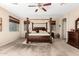A spacious bedroom showcasing a canopy bed, neutral walls, and plush carpeting at 1213 W Deoni Trl, San Tan Valley, AZ 85143