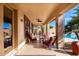 Inviting covered patio featuring comfortable seating with a view of the sparkling pool and water feature at 1213 W Deoni Trl, San Tan Valley, AZ 85143