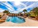 Backyard pool with desert landscaping, waterfall feature, surrounding privacy fence, and sunny skies at 1213 W Deoni Trl, San Tan Valley, AZ 85143