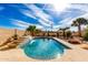 Pool with desert landscaping, rock features and mature foliage in a private backyard oasis at 1213 W Deoni Trl, San Tan Valley, AZ 85143