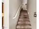 Carpeted staircase with white railing and decorative lighting; staircase to upper level at 1213 W Deoni Trl, San Tan Valley, AZ 85143